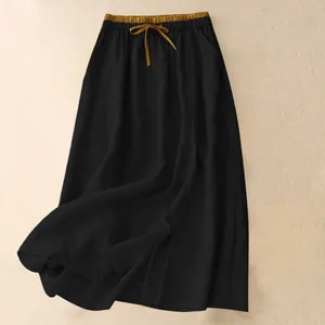 Black cotton linen maxi skirt featuring a gold elastic drawstring waistband