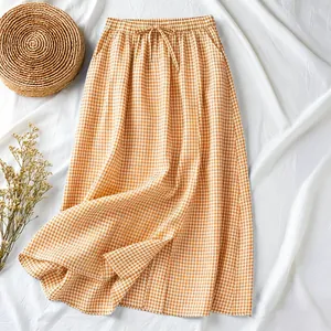 Detailed view of the orange gingham cotton linen midi skirt with a drawstring waist