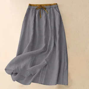 Macro shot of a vintage grey linen maxi skirt showcasing texture and elasticated waist