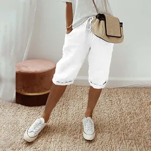 Detail of white cotton linen capris with elastic drawstring waist and side pockets