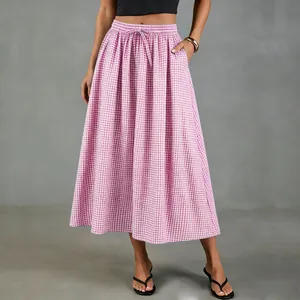 Model wearing a pink gingham cotton linen A-line midi skirt with drawstring waist