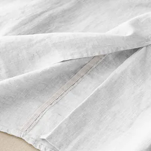 Close-up of breathable white cotton linen fabric and seam detail for midi skirt