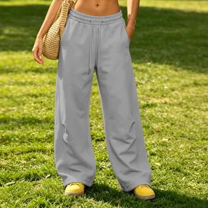 Casual grey wide-leg sweatpants with drawstring waist and pockets on green lawn