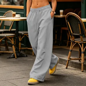 Focus on the drape and fit of light gray wide-leg sweatpants in a street setting.