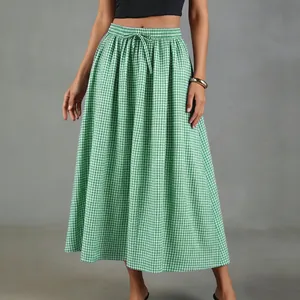 Close-up showing the texture of a green and white gingham cotton linen midi skirt
