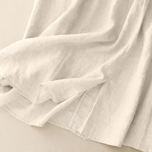 Detailed close-up of a beige cotton linen midi skirt showing premium fabric texture