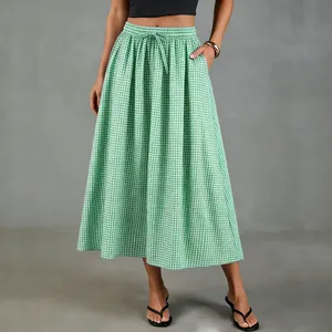 Full-length view of a green gingham cotton-linen A-line midi skirt on model