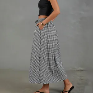 Detailed side view of a high-waisted black and white gingham cotton linen A-line skirt