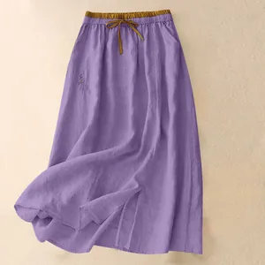 Detailed view of purple linen maxi skirt featuring brown elastic waistband and drawstring