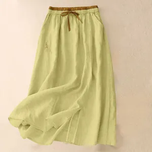 Detail shot of chartreuse high-waisted linen skirt with elegant side embroidery