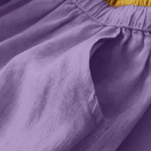 Close-up of purple linen skirt showing pocket detail and elastic waistband texture