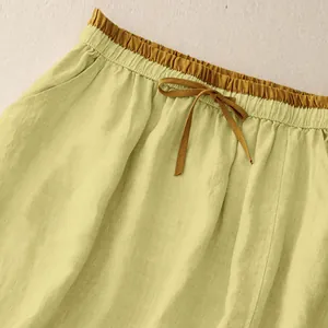 Detail of a retro cotton linen skirt featuring an elastic waistband with a drawstring.