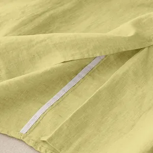 Macro view of breathable light green cotton linen skirt fabric texture