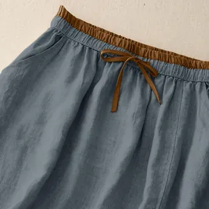 Close-up of retro cotton linen skirt waist with brown elastic band and bow detail