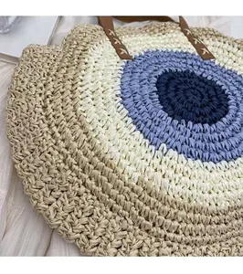 Detail macro view showing the intricate texture of a circular woven blue straw beach bag