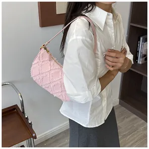 Detailed view of fashionable pink frayed denim hobo bag with lattice pattern on female model