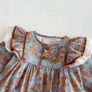 Baby girl long sleeve floral romper with vintage print, cute lace ruffles and brown trim.