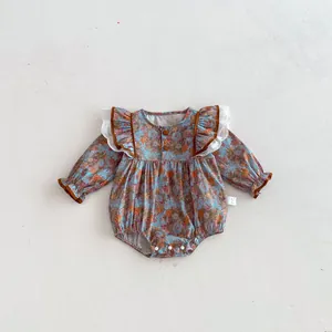 Cute baby long-sleeve floral romper with lace ruffles and cute brown trim for infant girls.