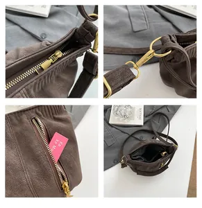 Brown hobo bag detail shot featuring smooth metallic zipper and durable gold-tone strap hardware.