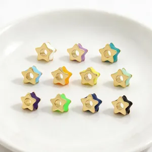 Macro view showing a collection of colorful star-shaped enamel beads for DIY jewelry