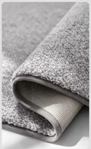 Close-up detail of grey plush flocked bathroom mat showing thick fibers and non-slip backing