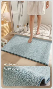 Macro view of soft plush light blue absorbent bath mat with reinforced edge detail