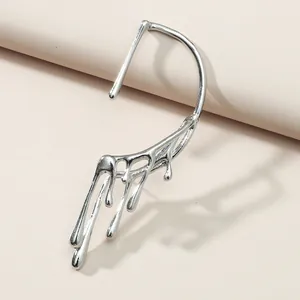 Detailed shot of liquid metal style silver ear cuff with melting drip design