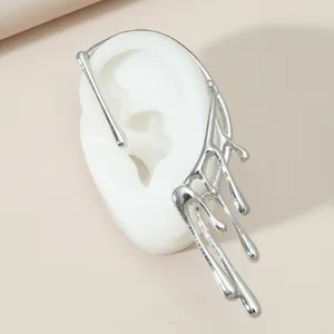 Close-up of a silver liquid-style ear cuff displayed on a white silicone model ear