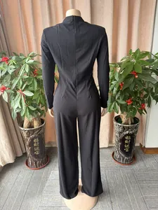 Back view detailing the high-waist tailoring and long sleeves of a black jumpsuit