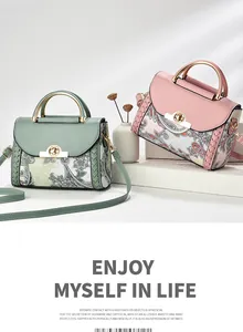 Detailed view of two elegant retro print handbags in green and pink colors