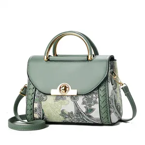 Elegant green vintage floral print handbag with golden top handle and shoulder strap