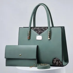 Elegant green handbag set including a matching wallet and strap with gold hardware