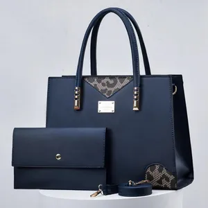 Sophisticated dark blue women's handbag set with leopard print accents and gold hardware