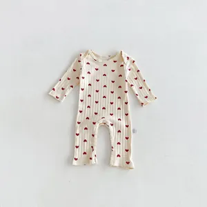 Cute baby long sleeve romper with red heart print, soft cotton fabric for newborn infants.