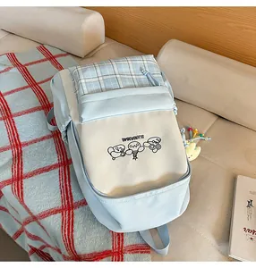 Cute Japanese style plaid backpack for girls, fresh school bag for students and daily commuting.