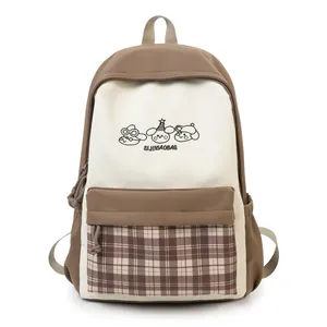 Cute Japanese style campus backpack for teen girls school bag with plaid front pocket design.