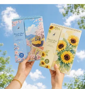 Detailed view of two portable watercolor coloring books with floral and scenic cover designs