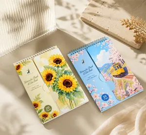 Detailed view of portable travel watercolor sketch books with sunflower and scenic covers