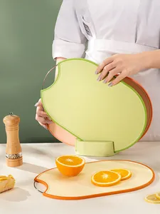 Set of three colorful plastic cutting boards with vertical storage stand for kitchen use