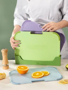 Detail view of a 3-piece multi-color non-slip cutting board set with a storage base