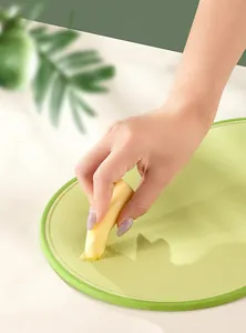 Close-up of a light green plastic cutting board featuring a functional grinding surface
