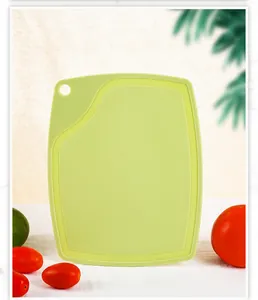Light green PP plastic cutting board for fruits and vegetables in a kitchen setting