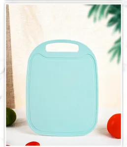 Detailed view of a light blue food-grade PP plastic cutting board with a textured surface