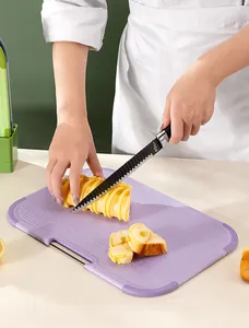 Macro view of slicing bread on a purple baby cutting board with cm and inch scale markings