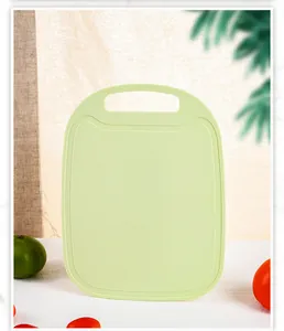 Close-up of green food-grade PP plastic cutting board with textured non-slip surface