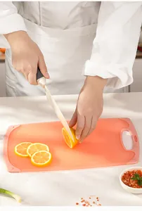 Detail view of a durable wheat straw cutting board being used to slice a fresh lemon