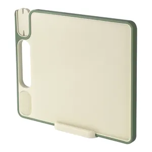 Multifunctional cream and green plastic cutting board with built-in sharpener and grinder.