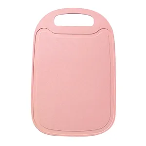 Durable pink wheat straw cutting board with handle and juice groove for home kitchen