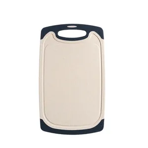 Durable wheat straw cutting board with non-slip corners and handle for kitchen use