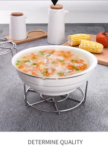 Detail of a stainless steel steaming rack supporting a food bowl on a textured gray mat